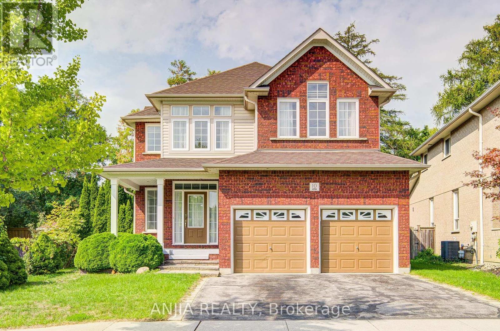 Detached Whitby home with two tan garage doors